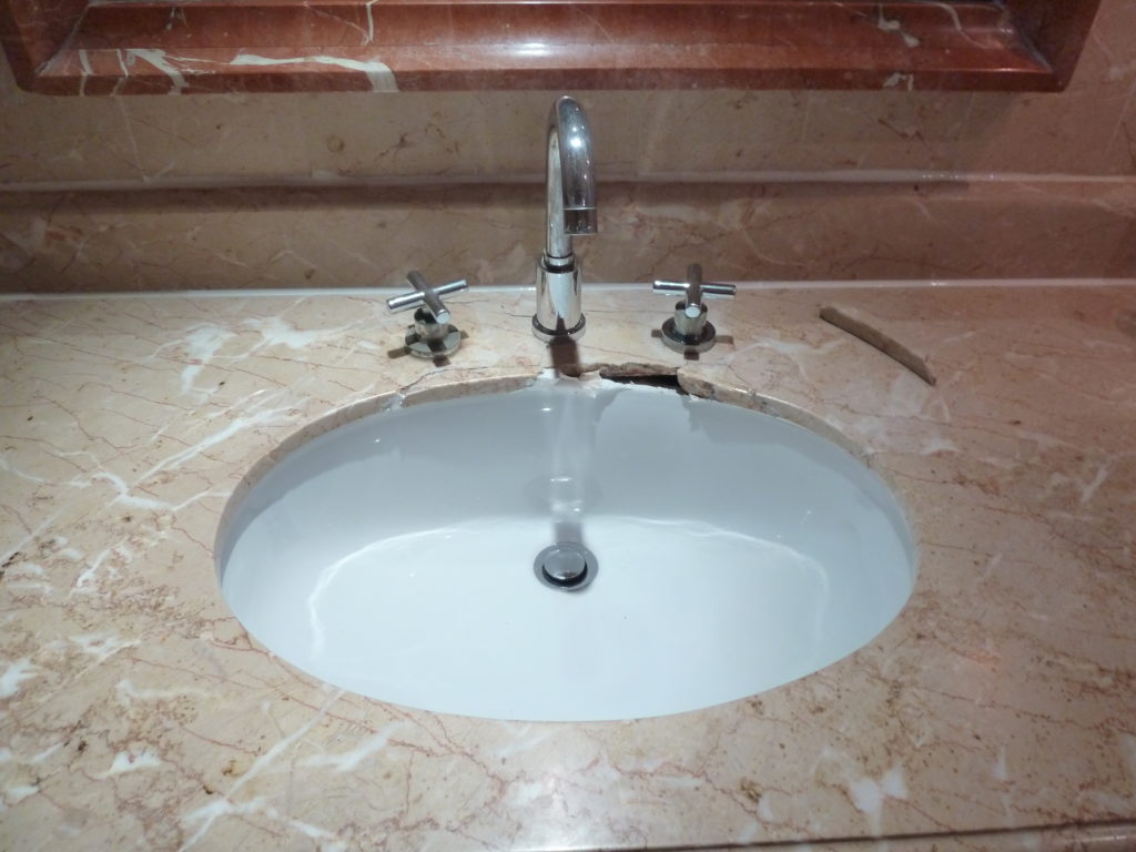 Damaged marble sink before repairs